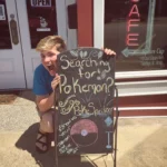 The Square Cup employee posing with a sign.