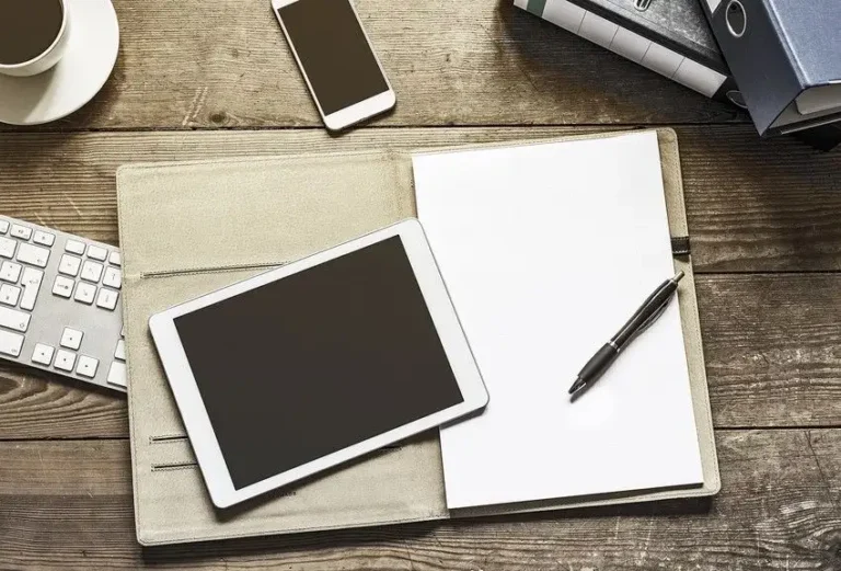 tablet, phone, paper, and pen