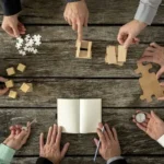 Hands moving puzzle pieces in a circle