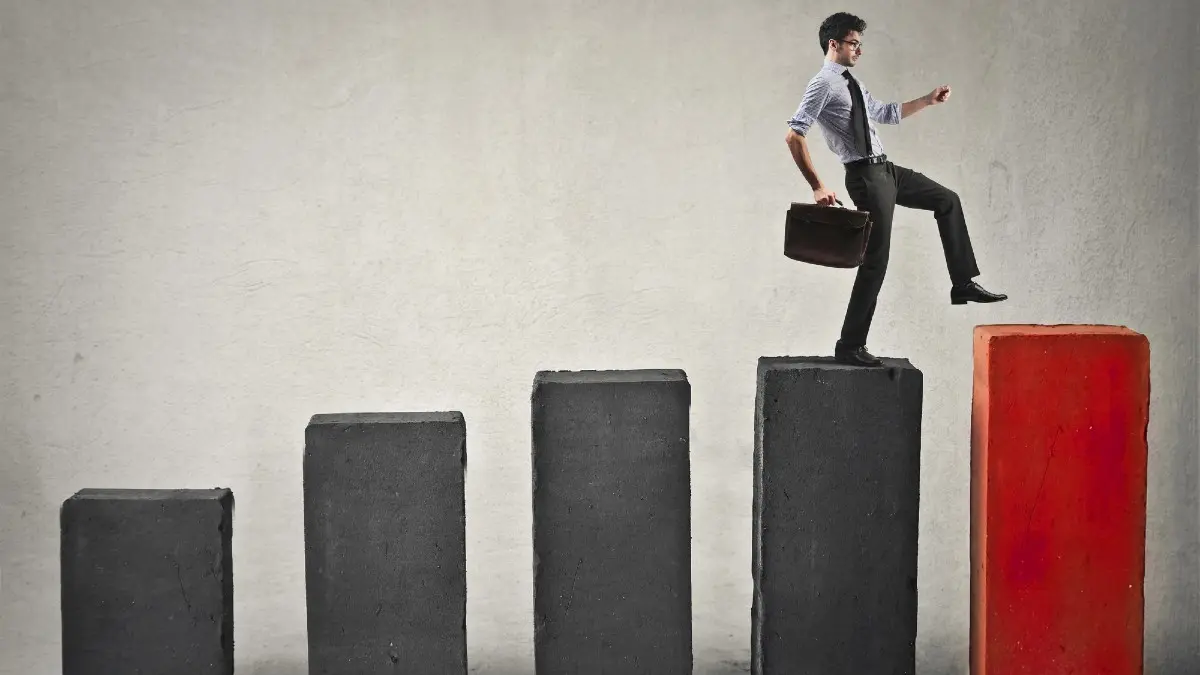 man with briefcase climbing his way up the career ladder