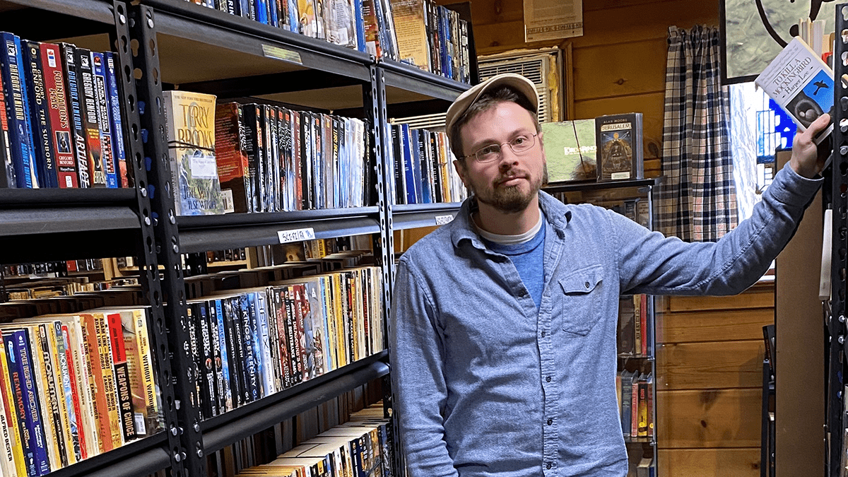 Second Time Books' owner, Brandon Hartman, in his bookstore