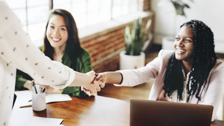 Business owner shaking hands with customers