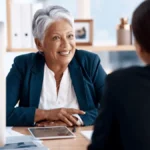 Two workers discuss benefits administration.