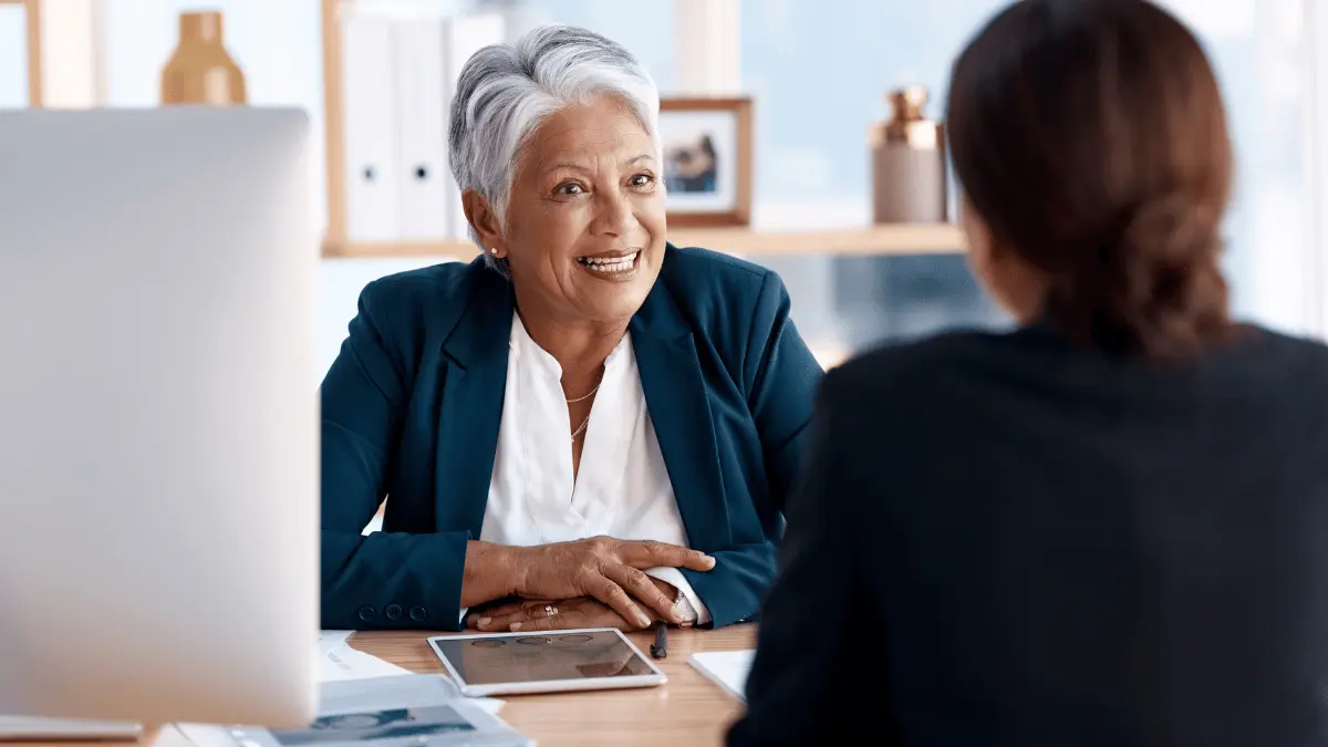 Two workers discuss benefits administration.