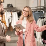 Saleswoman on a tablet talking to a customer.