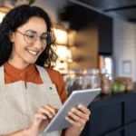 Barista using tablet as part of a small business digital transformation.