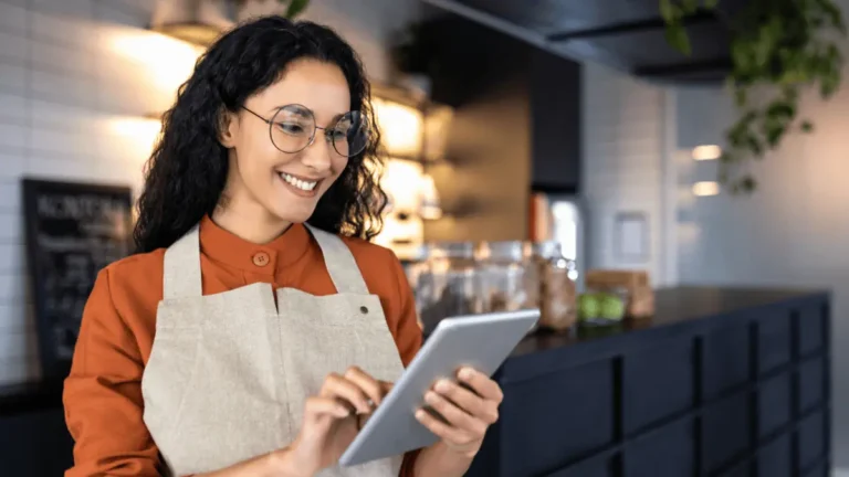 Barista using tablet as part of a small business digital transformation.