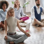 Employees meditating as they advantage of mental health initiatives in the workplace.