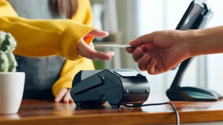 Customer handing employee a credit card.